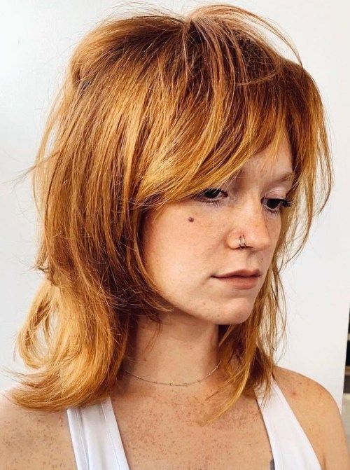 Bright ginger voluminous wolf haircut with vibrant color