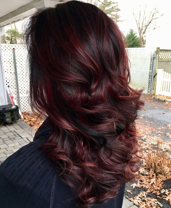 Achieve a stunning burgundy hair effect with red wine highlights on an espresso base. This rich cherry hue looks striking in the light.