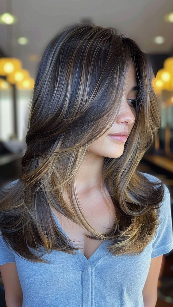 Feathered layers giving a soft, wispy texture to long hair.