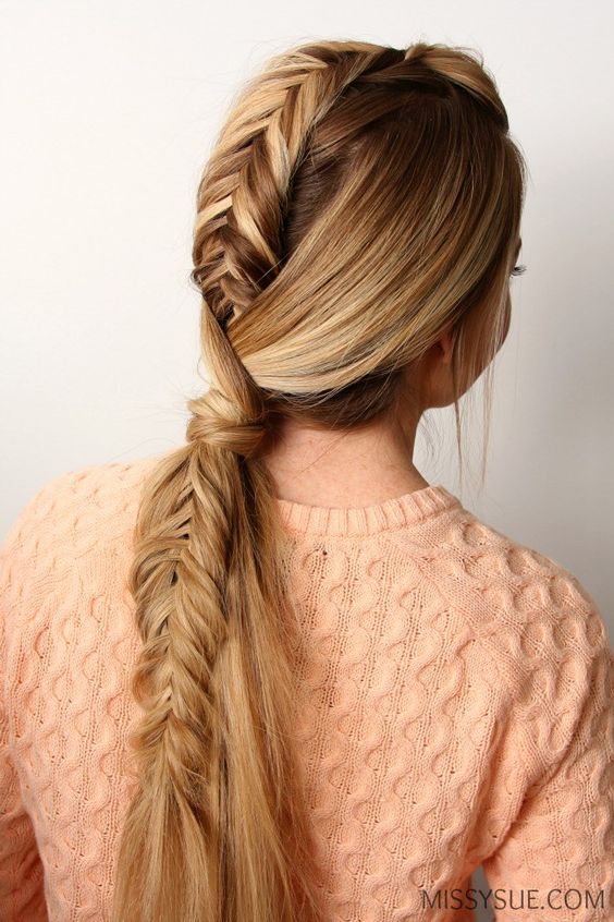 Edgy fishtail Mohawk ponytail featuring a central fishtail braid and high sides for a bold, statement look.