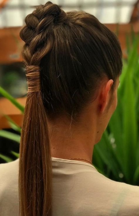 Half-braided low ponytail hairstyle with intricate braids.