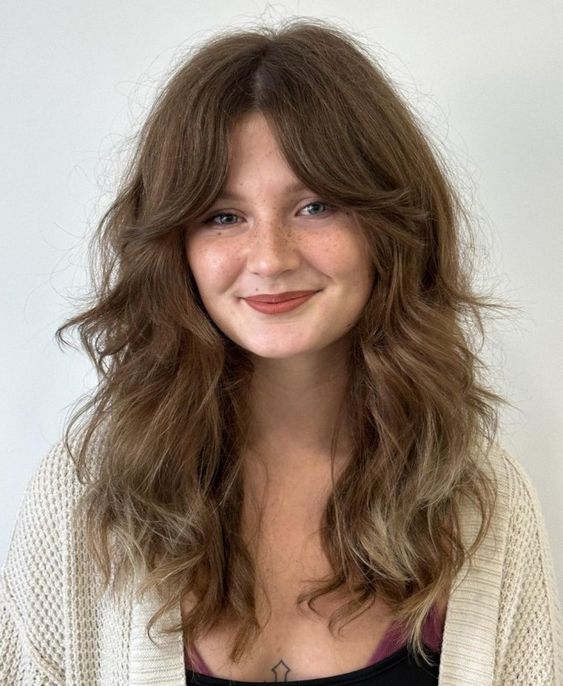 A woman with a messy shag haircut featuring tousled layers and a casual look.