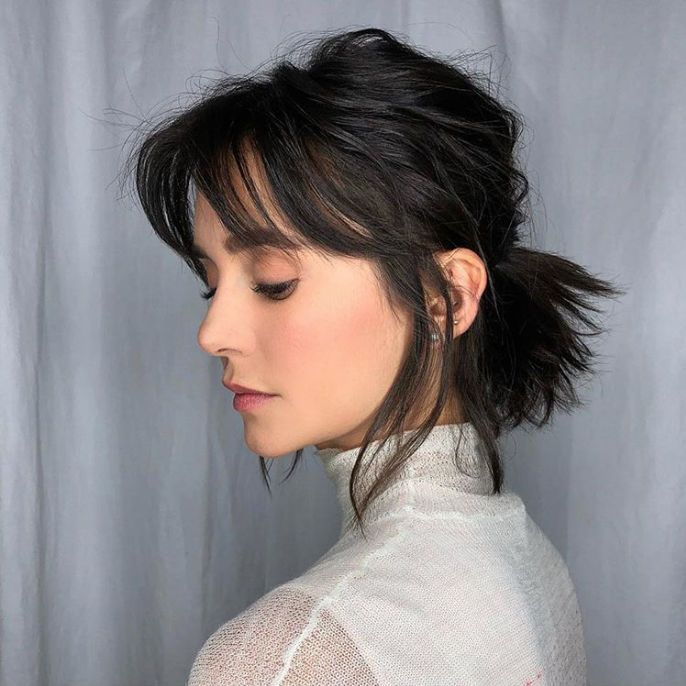 Casual short shaggy ponytail with tousled layers and a laid-back, effortless appeal