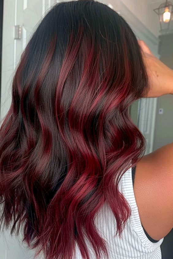 Achieve a calm, elegant vibe with dark red hair color. Perfectly placed cherry highlights add sophistication to your look.