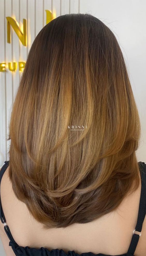 Soft U-cut layers providing a rounded and feminine shape for long hair.