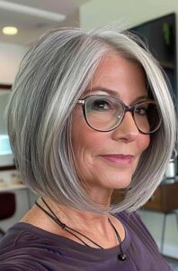 Angled side-part bob gray hairstyle for women over 70.