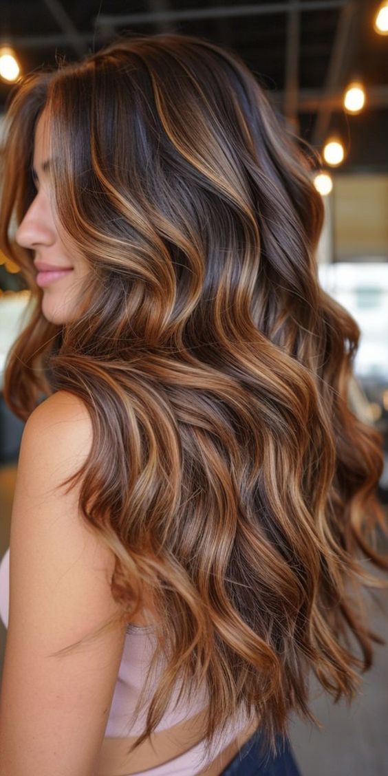 Woman with caramel balayage on long wavy hair