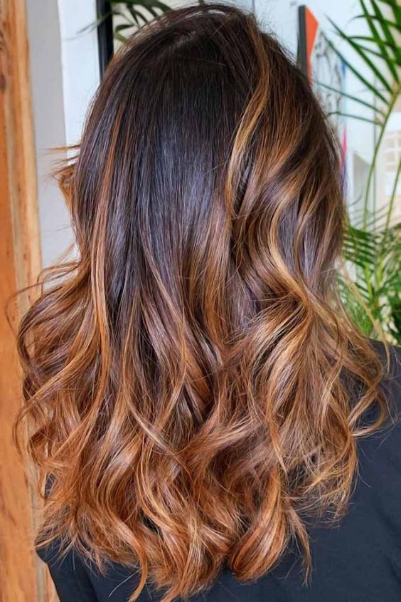 Caramel ombre hair on a woman with long straight hair