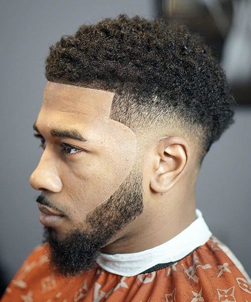 Curly top with faded sides, balancing the look of a long face