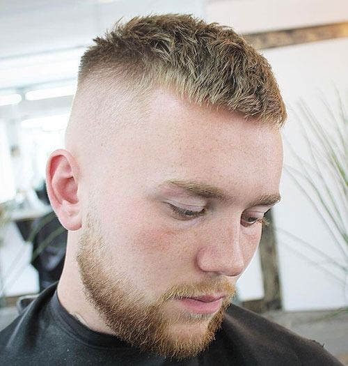 Man with a high and tight haircut, inspired by military styles.