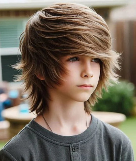 Kid with a trendy long shag hairstyle featuring textured layers.