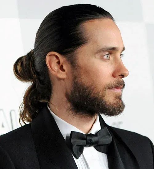 Man with a man bun hairstyle, perfect for keeping long hair cool in summer.