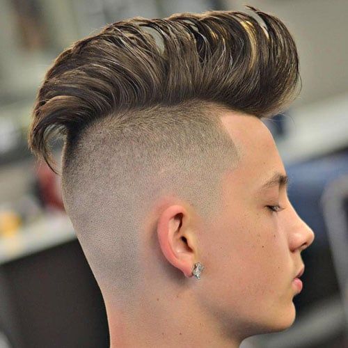 Man with an undercut Mohawk showing a stark contrast between the long top and shaved undercut.