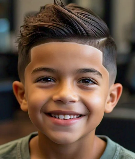 Boy with a taper fade haircut, gradually shorter towards the neckline.