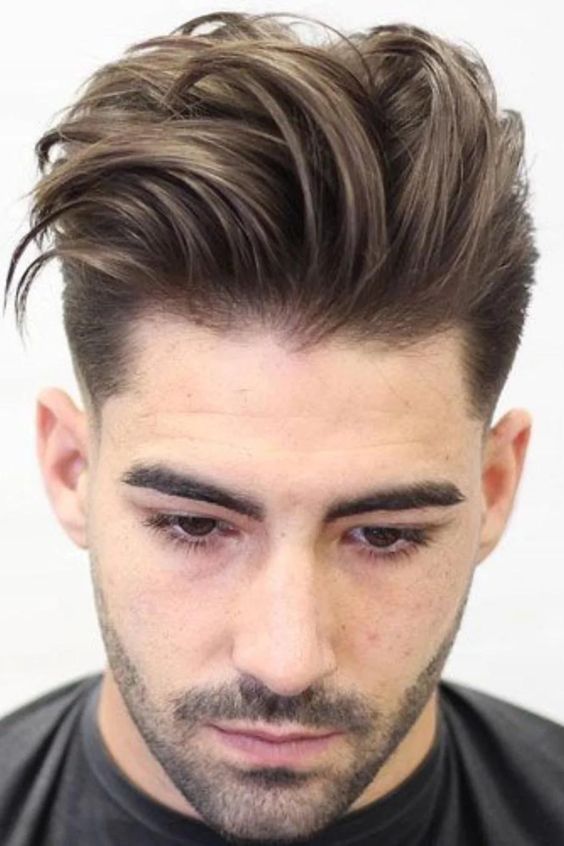 Man with a textured quiff hairstyle, combining volume and texture.